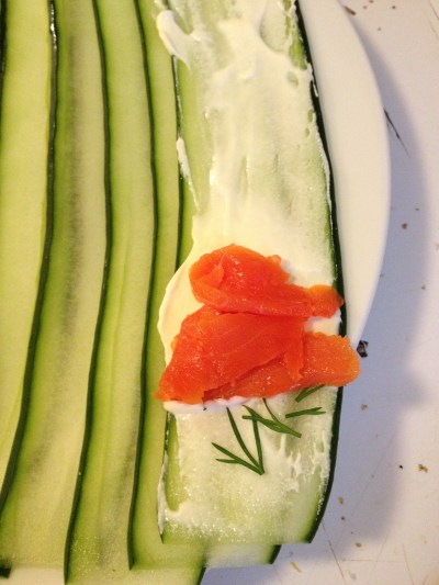 Setting the cucumber strips side by side makes cream cheese application much easier than when they are stacked on top of each other.